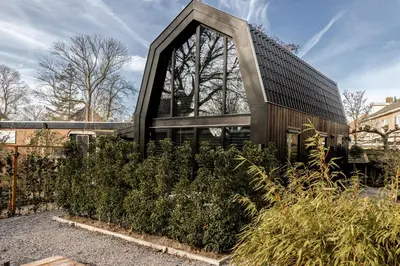 a building with a lot of plants in front of it at Lovely private cottage near Amsterdam in Broek in Waterland