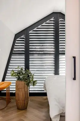 a bedroom with a bed and a large window at Lovely private cottage near Amsterdam in Broek in Waterland