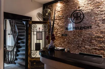 a room with a brick wall and a staircase at Hotel Amstelzicht in Amsterdam