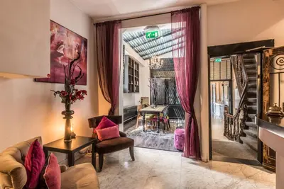 a living room with a couch and a chair and a window at Hotel Amstelzicht in Amsterdam