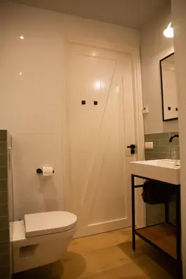 a bathroom with a toilet and a sink at Eco lodge Duin- unieke locatie -strand, duin en nabij cultuursteden in Castricum