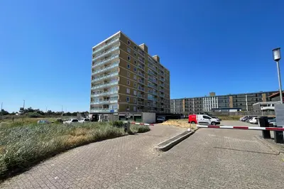 an empty road in front of a tall building at Apartment Garden & Bed in Zandvoort