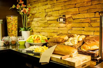 a buffet with bread and other foods on a table at Fletcher Hotel Restaurant Amersfoort in Amersfoort