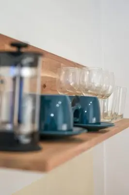a wooden shelf with glasses and plates on it at Riverbridge Suite - Historic Center Canal District in Amsterdam