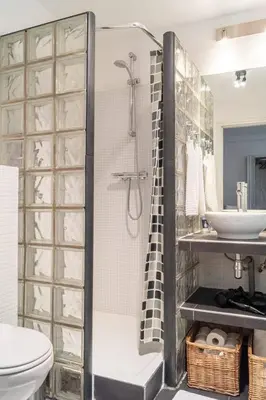 a bathroom with a shower and a toilet and a sink at Riverbridge Suite - Historic Center Canal District in Amsterdam