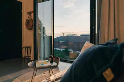 a room with a large glass window with a table at Elegant Boutique Apartment 45m2 w Amazing Views in Amsterdam