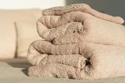 a pile of towels sitting on top of a bed at Elegant Boutique Apartment 45m2 w Amazing Views in Amsterdam