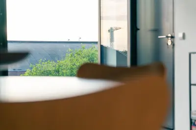 a chair in front of a window with a view at Elegant Boutique Apartment 45m2 w Amazing Views in Amsterdam
