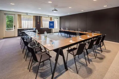 a large conference room with a large table and chairs at NH Amsterdam Leidseplein in Amsterdam