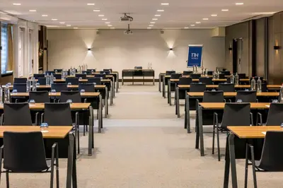 an empty classroom with tables and chairs at NH Amsterdam Leidseplein in Amsterdam