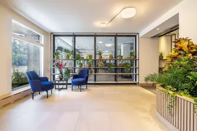 an office with blue chairs and a large window at NH Amsterdam Leidseplein in Amsterdam