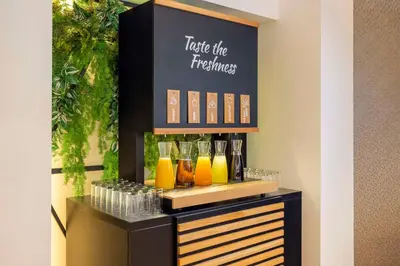 a drink bar with glasses on a shelf at NH Amsterdam Leidseplein in Amsterdam