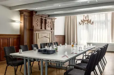 a conference room with a long table and chairs at NH Collection Amsterdam Barbizon Palace in Amsterdam