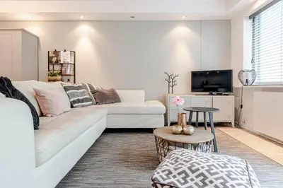 a living room with a white couch and a tv at Summer House in Zandvoort