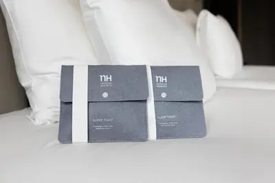 three boxes sitting on top of a bed at NH Amsterdam Caransa in Amsterdam