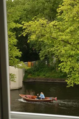 two people in a boat in the water at Canal View Stay Amsterdam in Amsterdam