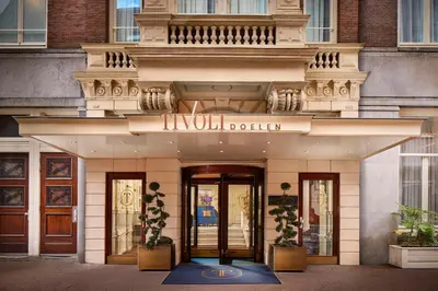 a building with a sign on the front of it at Tivoli Doelen Amsterdam Hotel in Amsterdam