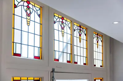 a group of stained glass windows in a room at NH Amsterdam Schiller in Amsterdam