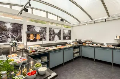 a large kitchen with a lot of food at NH Amsterdam Schiller in Amsterdam
