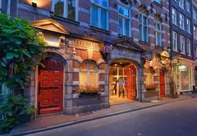 a building with red doors on a city street at Best Western Dam Square Inn in Amsterdam