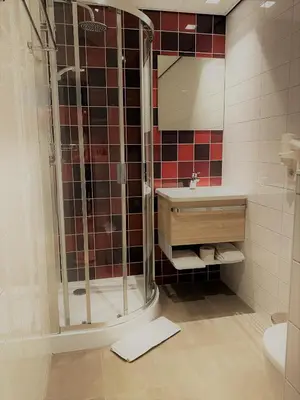 a bathroom with a shower and a sink at Best Western Dam Square Inn in Amsterdam