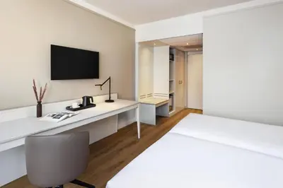 an office with a desk and a tv on a wall at NH Bussum Jan Tabak in Bussum