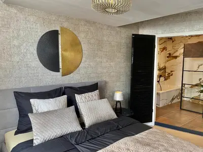 a bedroom with a bed with two pillows at Glücklich am Meer Suite Deluxe mit Wellnesszugang in Egmond aan Zee