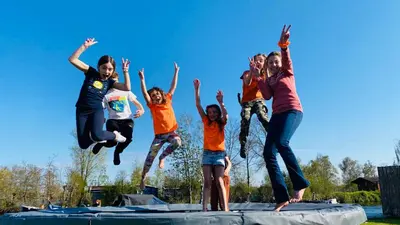 a group of children jumping on a trampoline at New - Waterfont Villa08 - Private Residence on a lake near Amsterdam in Vinkeveen
