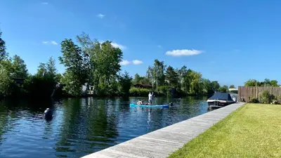 a group of people in a boat on a river at New - Waterfont Villa08 - Private Residence on a lake near Amsterdam in Vinkeveen