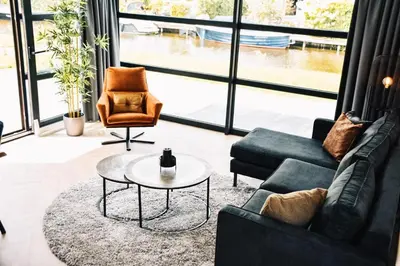 a living room with a couch and a table at MarinaPark Residentie Nieuw Loosdrecht in Loosdrecht