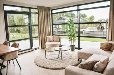 a living room with a couch and a table at MarinaPark Residentie Nieuw Loosdrecht in Loosdrecht