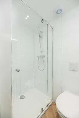 a glass shower in a bathroom with a toilet at MarinaPark Residentie Nieuw Loosdrecht in Loosdrecht