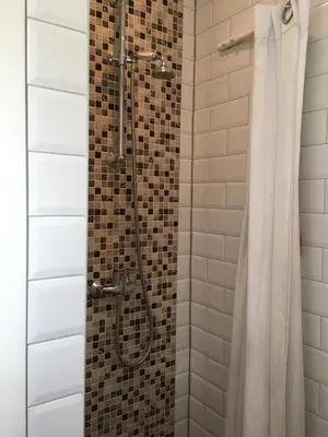 a shower in a bathroom with a shower curtain at Summerhouse Zandvoort in Zandvoort