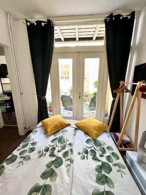 a bedroom with a bed in front of a window at Leiden City Centre Canal View or Terrace View Apartments in Leiden