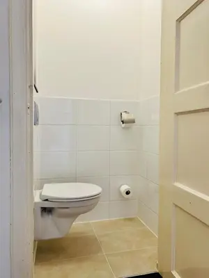 a bathroom with a toilet and a toilet paper roll at Leiden City Centre Canal View or Terrace View Apartments in Leiden