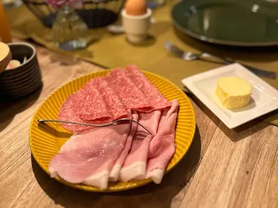 a plate of food with meat and cheese on a table at The Butchersfarm in Ter Aar