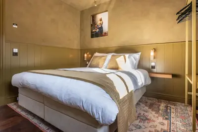 a bedroom with a large bed in a room at The Butchersfarm in Ter Aar