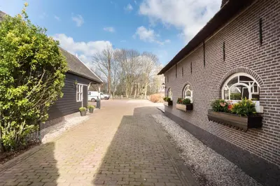 a brick building with flower boxes on the side of it at The Butchersfarm in Ter Aar
