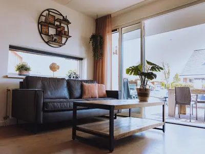a living room with a couch and a table at Apartment in Waterpark with Private Jetty in Uitgeest