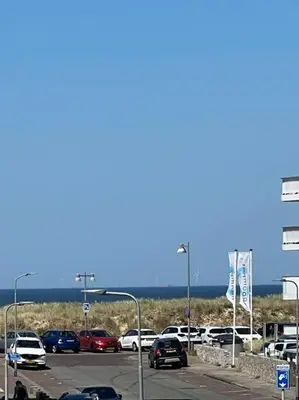a parking lot full of cars in a parking lot at Loft met zeezicht in Egmond aan Zee
