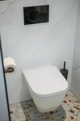 a bathroom with a white toilet in a room at Golden Tulip Leiden Centre in Leiden