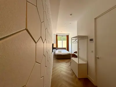 a room with a bedroom with a bed in it at Sunshine Suites in Utrecht