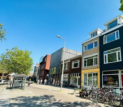 a street with a bunch of bikes parked in front of buildings at Sunshine Suites in Utrecht