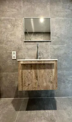 a bathroom with a sink and a mirror at Sunshine Suites in Utrecht