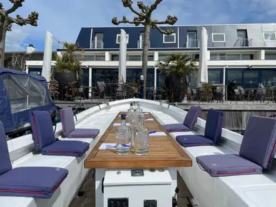 a table and chairs on a patio with a building at Fletcher Hotel Restaurant Loosdrecht-Amsterdam in Loosdrecht