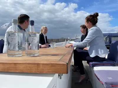 a group of people sitting at a table on a boat at Fletcher Hotel Restaurant Loosdrecht-Amsterdam in Loosdrecht