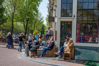 a group of people sitting outside of a building at Westerdok25 in Amsterdam