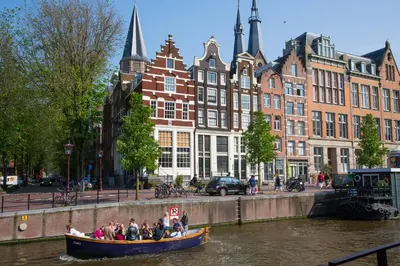 a group of people in a boat on a river at Westerdok25 in Amsterdam