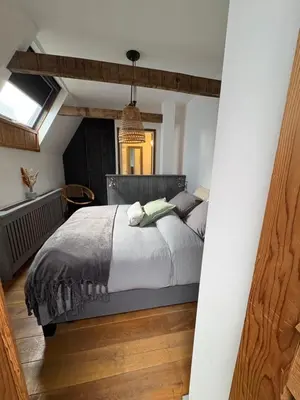 a bedroom with a bed and a window at Pothuis Zuid in Zandvoort