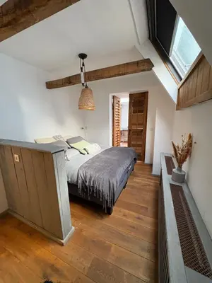 a bedroom with a bed and a vaulted ceiling at Pothuis Zuid in Zandvoort